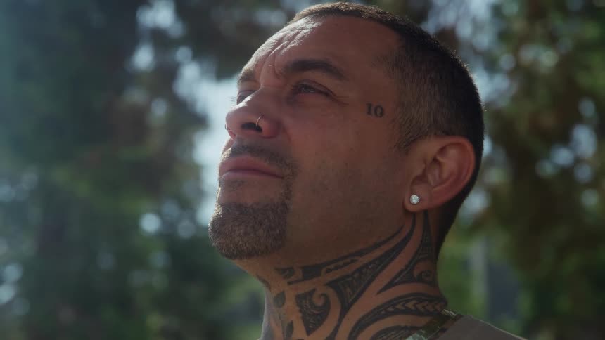 The mans neck is covered with tattoos