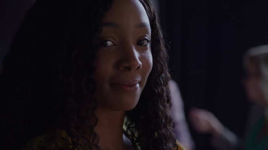 Woman smiling softly while looking