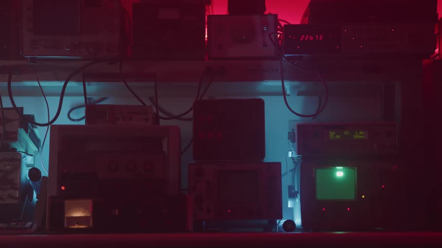 Several machines on shelves with backlit walls