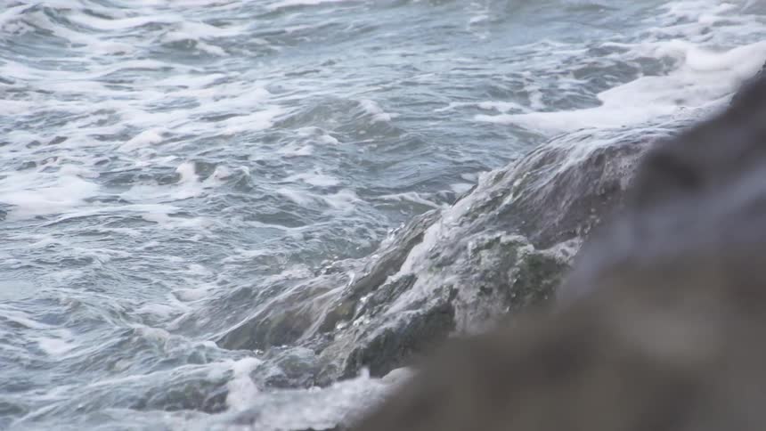 Waves crash on some rocks