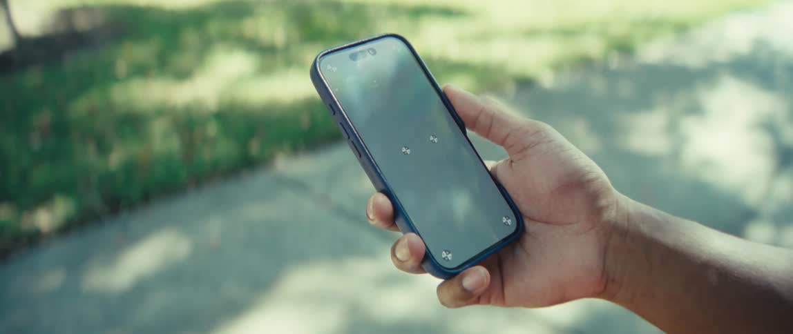 Man holding a smart phone with marks on the screen
