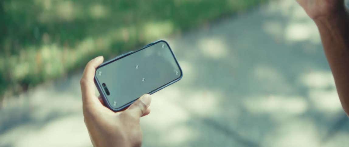 The man pumps his fist while looking at the phone