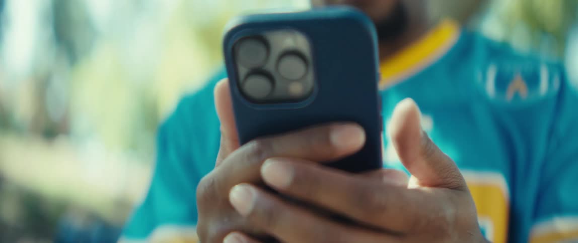 The man is tapping on his cell phone