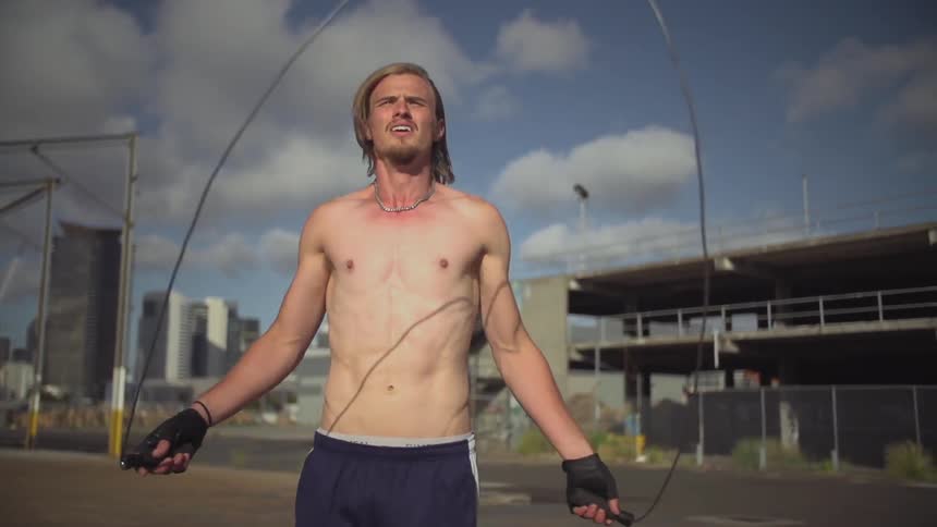 Man jumping rope on a cloudy day