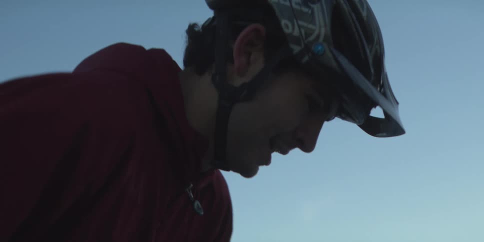 A man is wearing a bike helmet as he exercises in the mountains