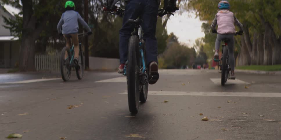 The children are riding bicycles in the neighborhood