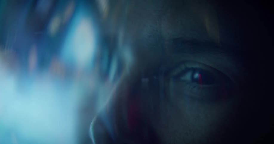 Glaring light shines onto a face