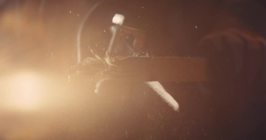 An extreme close up of a power saw  cutting into a piece of wood