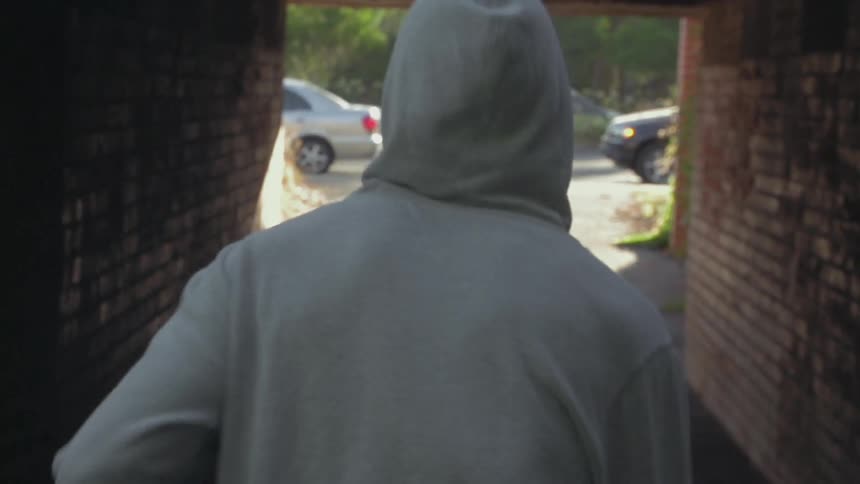 A man runs through a brick tunnel