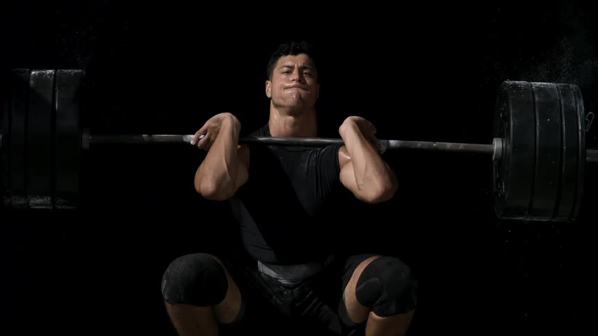 Man working out lifts heavy weights
