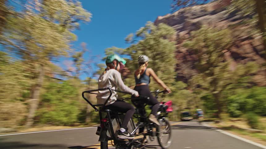 A couple people riding a bike