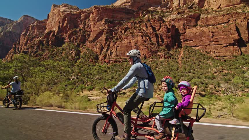 Several people riding along a road