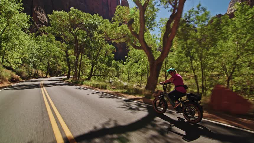 A cyclist biking down a street