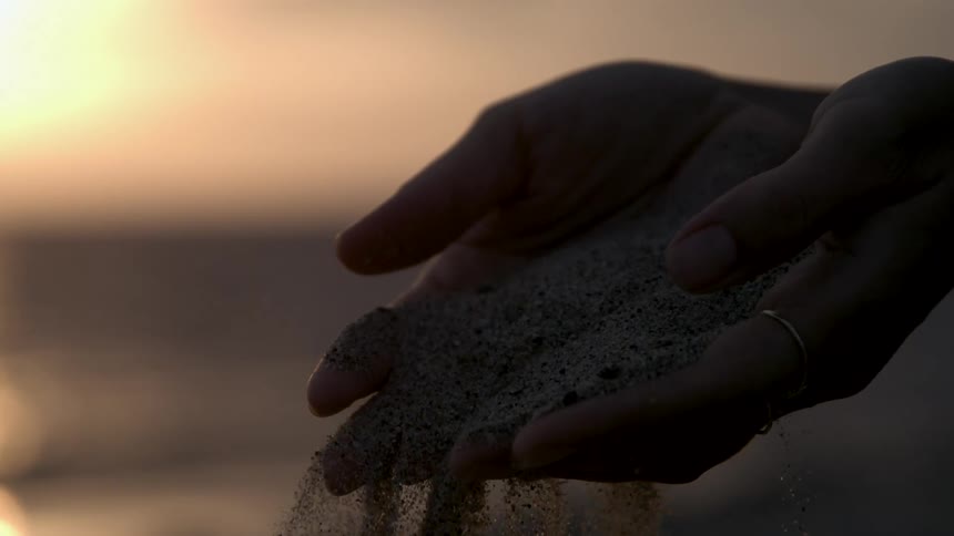 Sand falls through fingers like water
