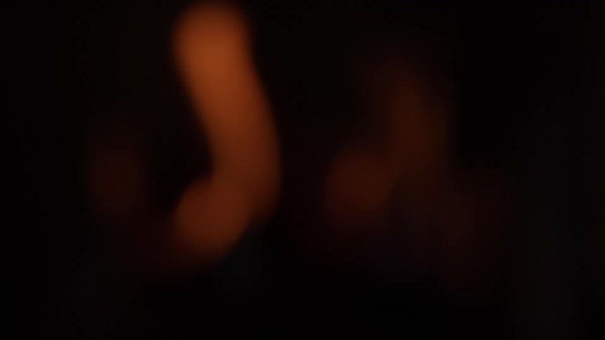 Blurred flames glowing amidst the darkness