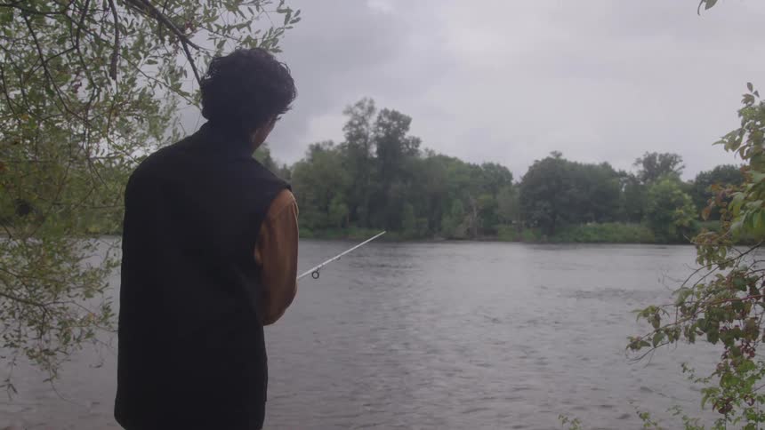 A man fishing in a stream