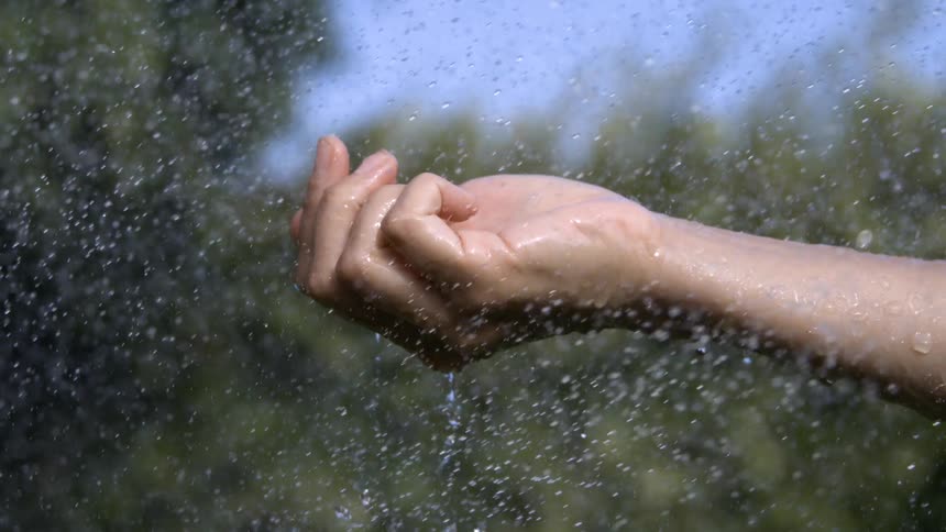 Water is being sprayed on the persons hand