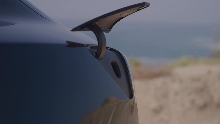 A finger presses a car panel the charging port door opens a hand holds a charging connector the charging connector plugs into the car port completing the vehicle charging connection
