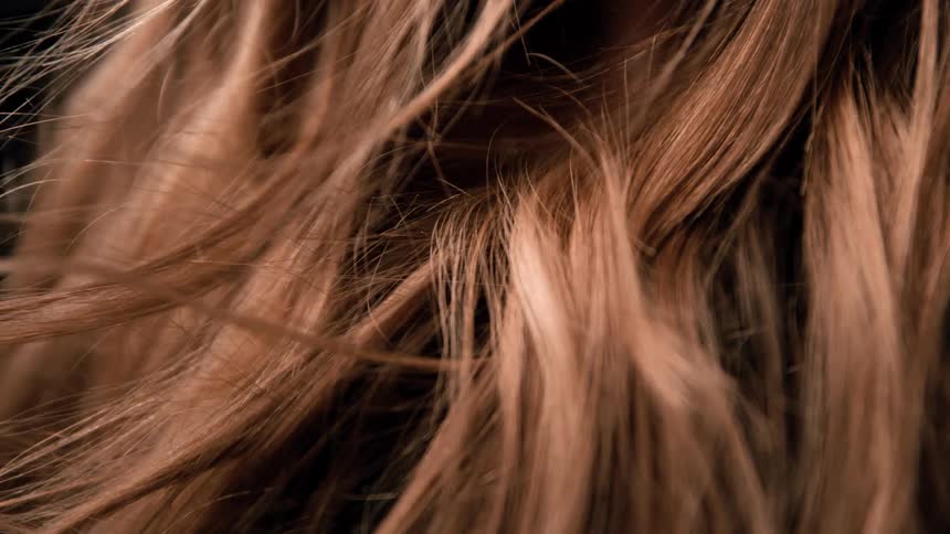 Brown strands flowing gently under soft light
