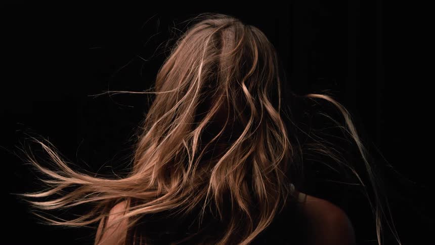 Long hair waving against a dark background
