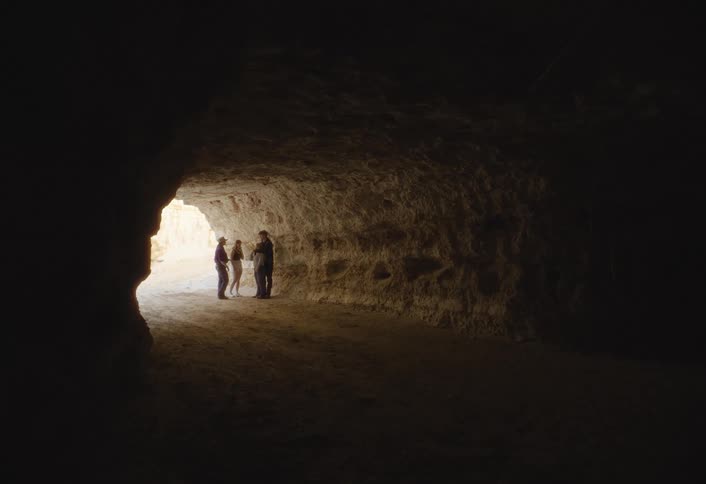4 friends are taking inside a cave in a midday