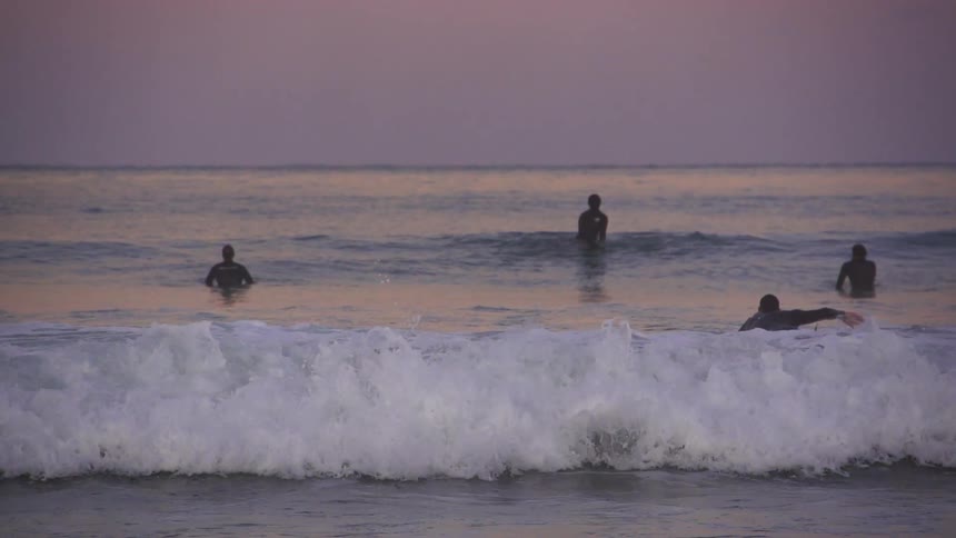 People out in the water by the shore