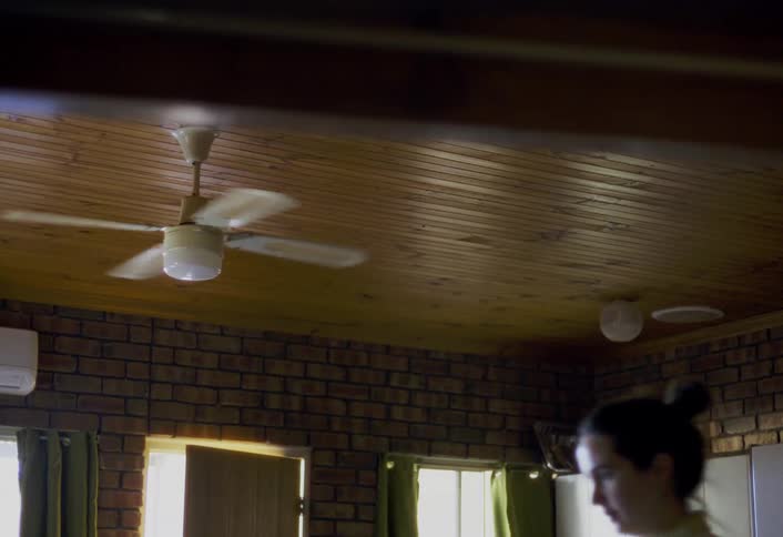 The woman walks through her home