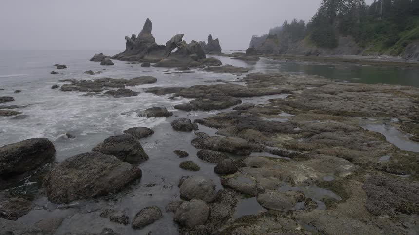 Waves crash against the rocks by the shore