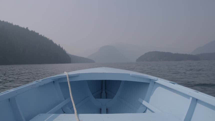 A boat's prow bobs on the waves