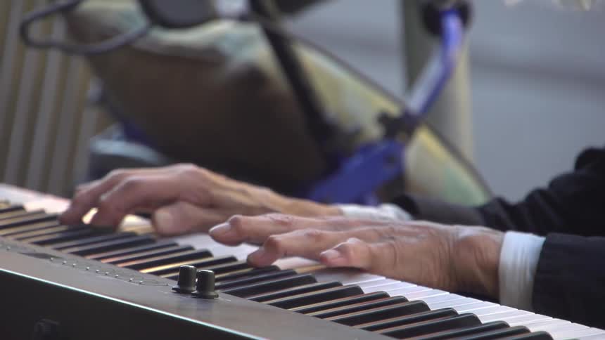 A man playing a piano by the street