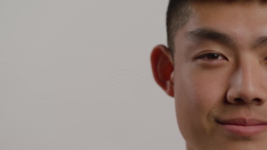Man partially visible looking at the camera with a slight smile