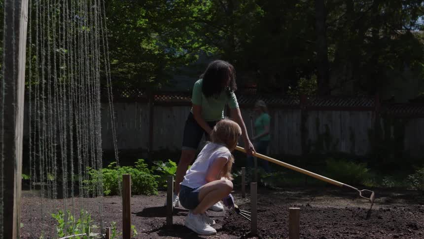 Two girls working on planting some plants