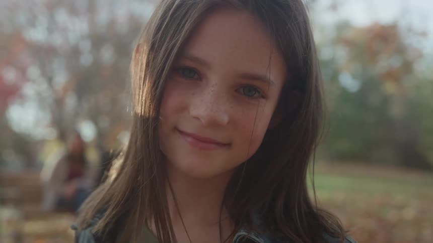 A portrait of a girl standing outdoors