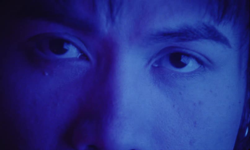 Man under intense blue lighting