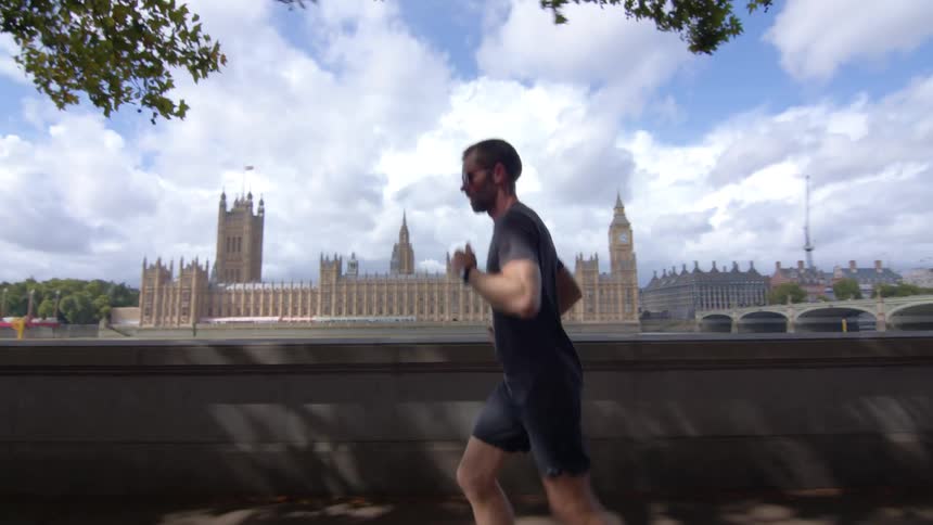 The man is jogging in the city