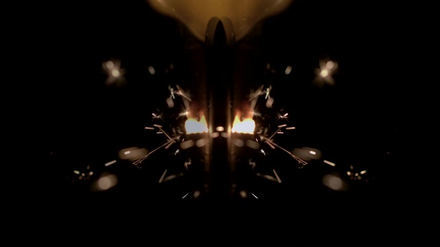 Closeup of glowing sparks and mirrored lights against a dark background