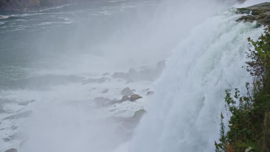 A waterfall cascades down into a river