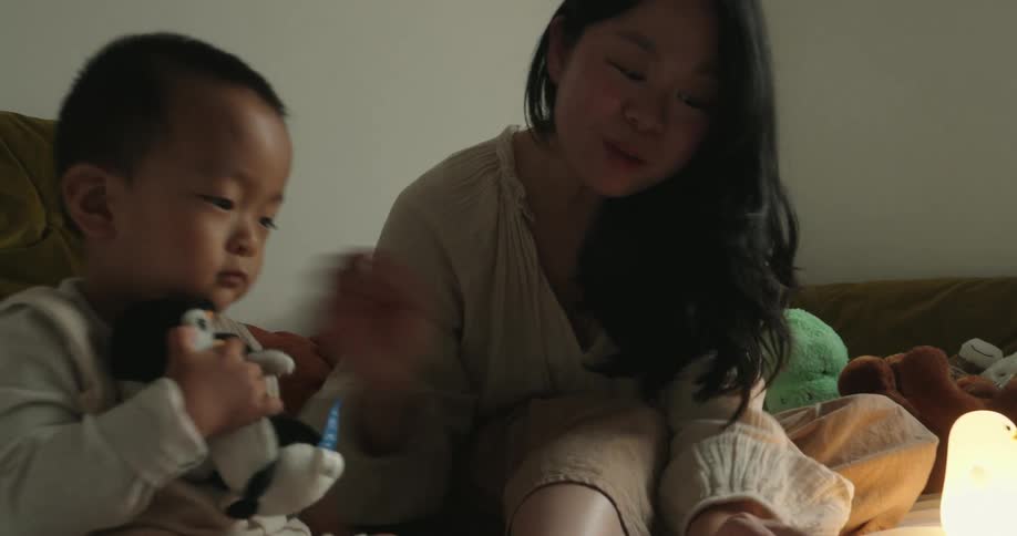 Mother and toddler playing with toys inside a room