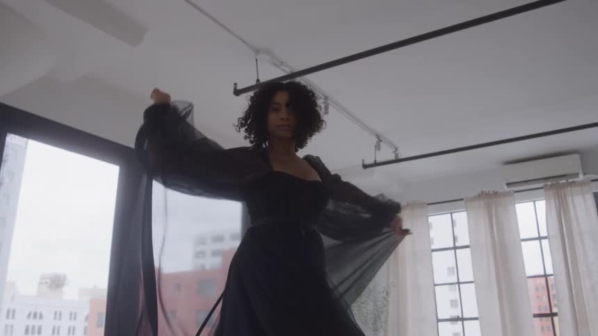 The woman spins in a black robe