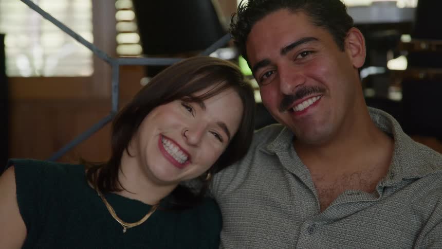 A couple posing for a portrait in a room