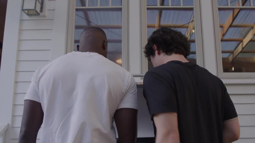 Two guys talking while grilling