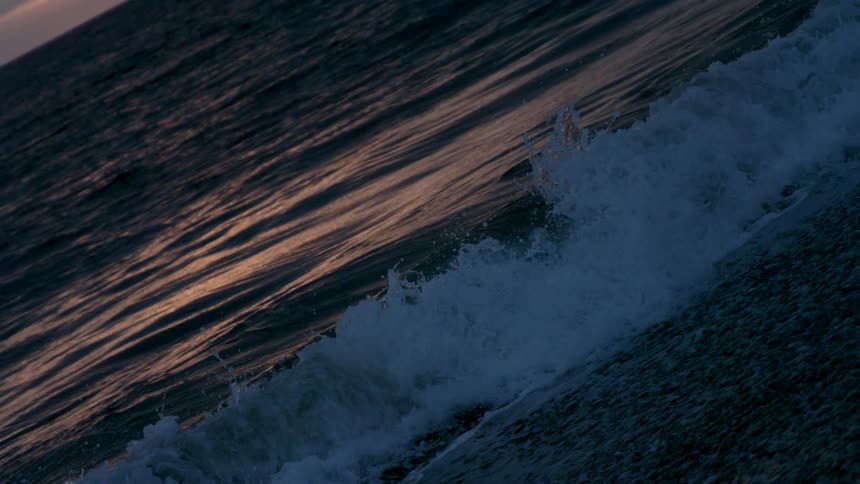 Waves roll and crash onto a beach
