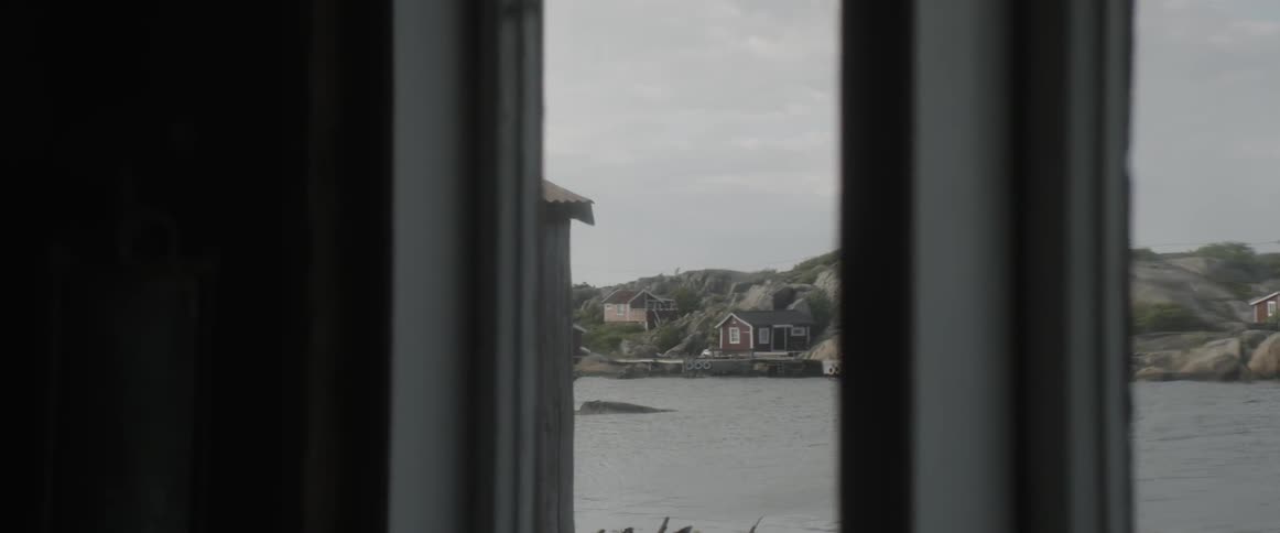 Looking through a window toward a body of water