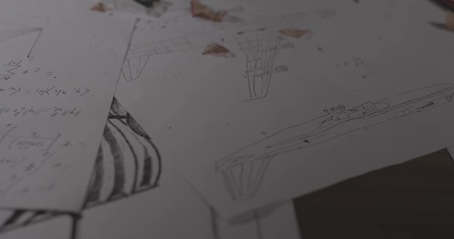 Pencil shavings on top of papers on a desk