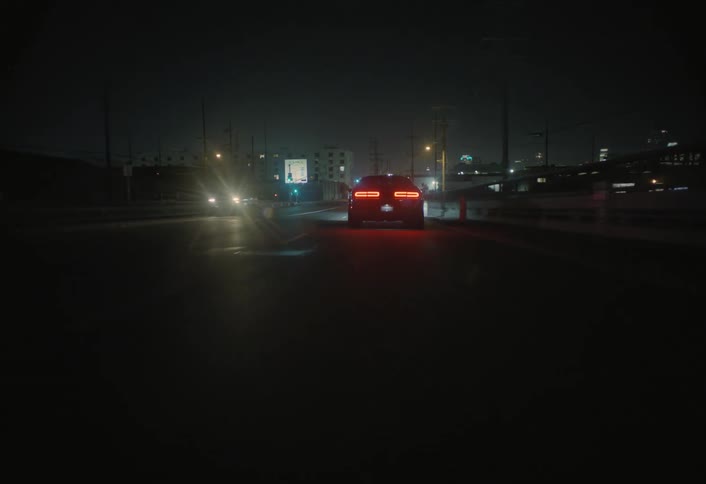 A car driving down a road at night