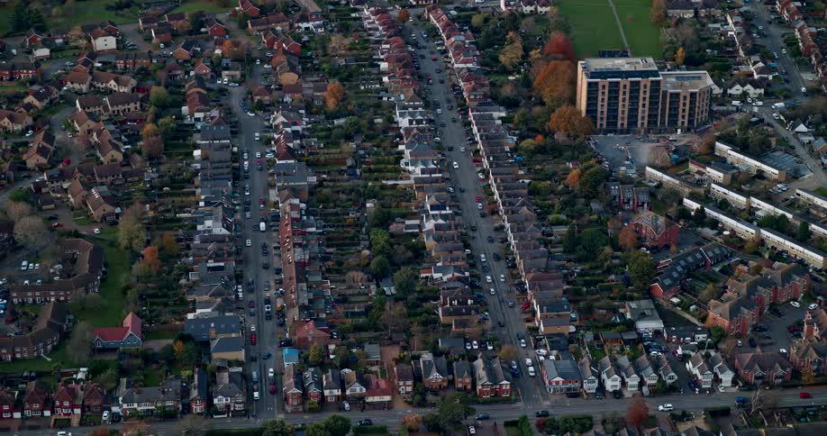 An aerial view of a suburban area with several houses and some trees around them
