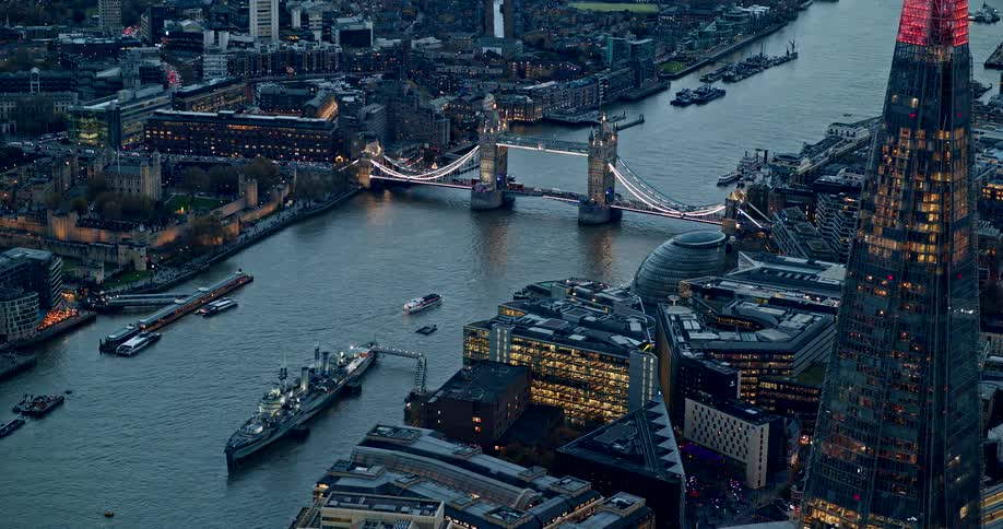 An aerial shot of london at twilight or dusk captures the tower bridge