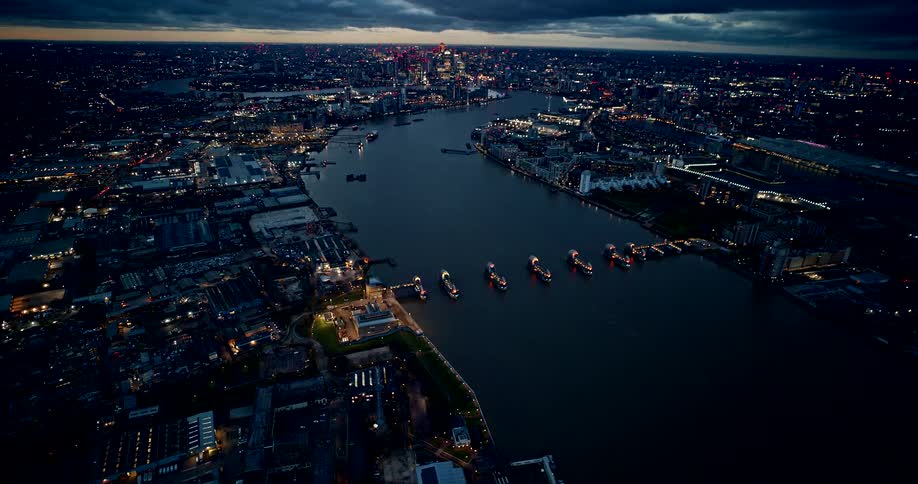A high aerial view captures a sprawling city and a wide river
