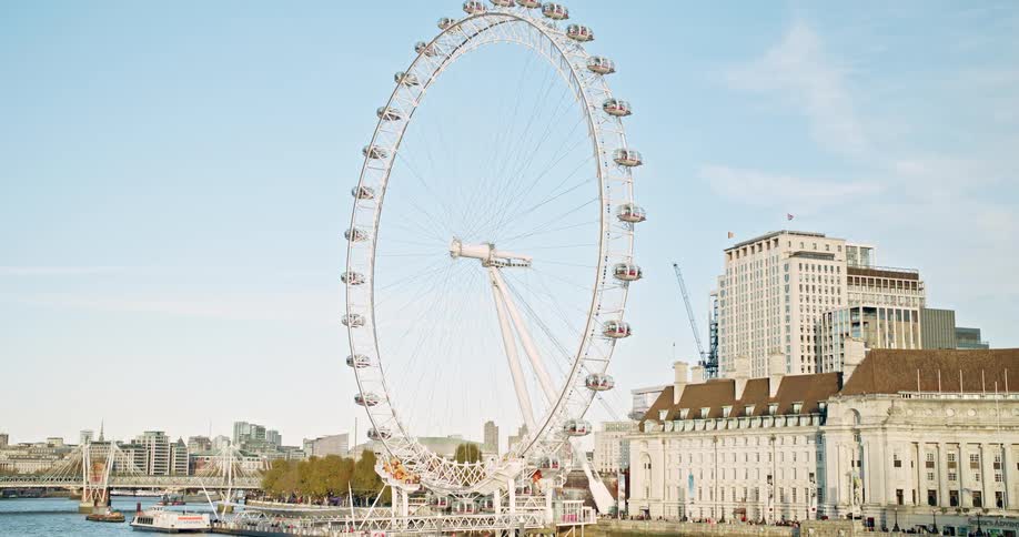 A ferris wheel in an amusement park in a metropolitan city during daytime