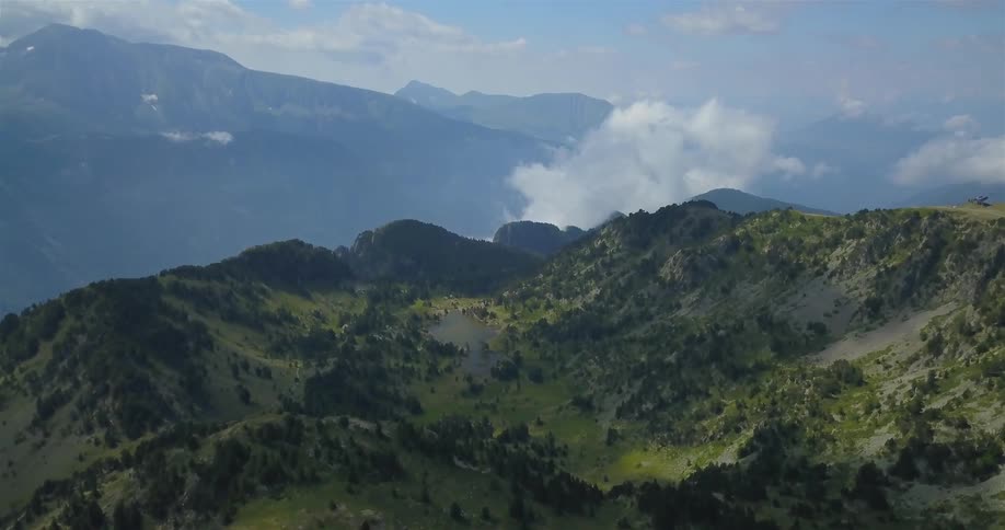 A long expanse of mountains is covered with green